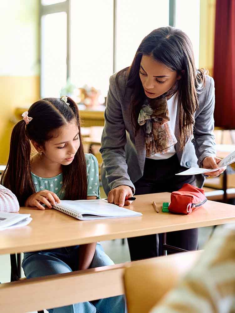 Teacher helping student.