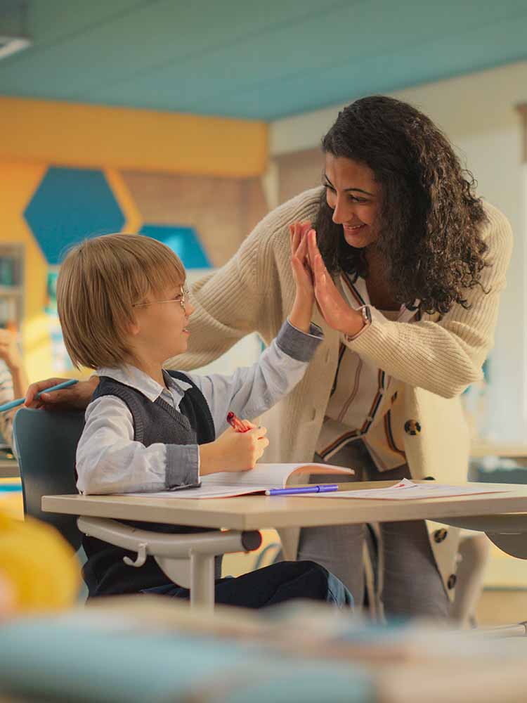 Teacher high-fiving student