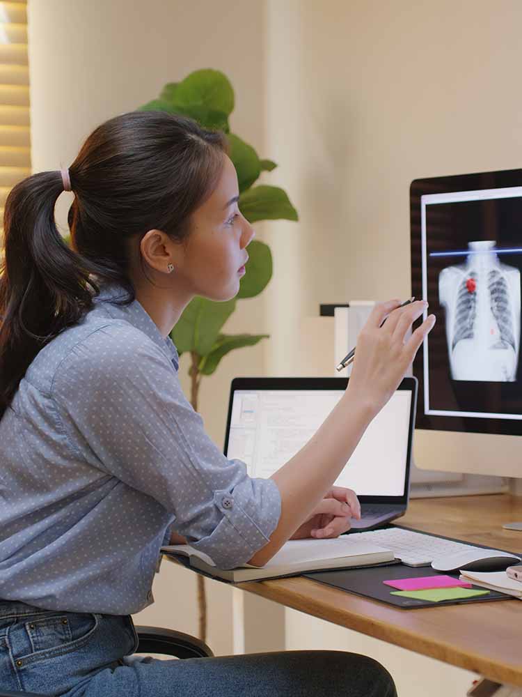 Health Informatoin Worker staring at skeleton.
