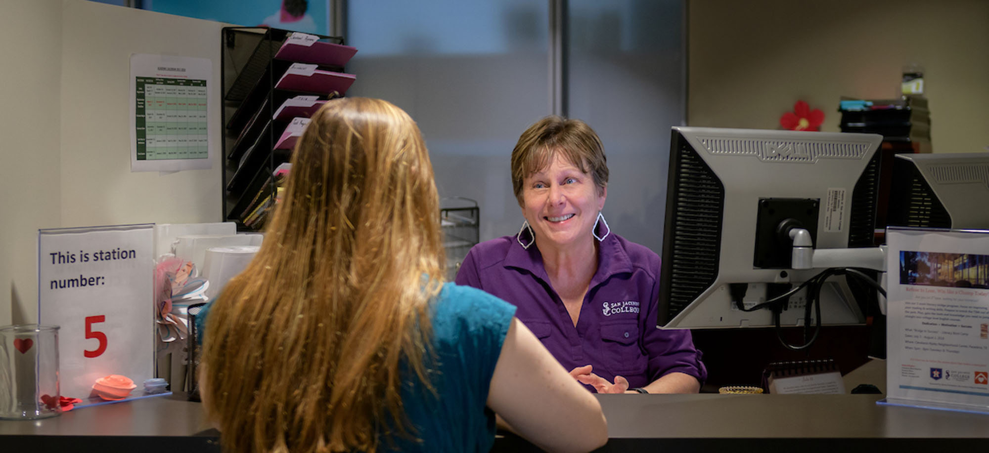 student speaking with staff member